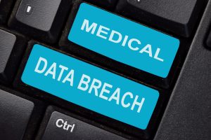 The words medical data breach printed in blue on a keyboard