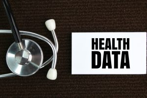 A stethoscope beside the words health data on a white box