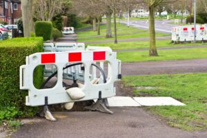 A barrier blocks off a section of pavement. 