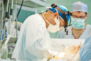 A surgeon operates on a patient as part of treating testicluar cancer. 