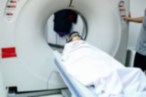 A patient is being scanned in an MRI machine to try and diagnose testicular cancer.