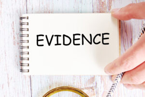 THE WORD 'EVIDENCE' WRITTEN ON A NOTEPAD