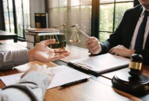 A road traffic accident solicitor and a client discuss a potential case while sat at a table