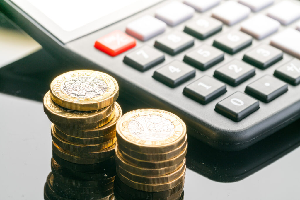 PILE OF MONEY NEXT TO A CALCULATOR