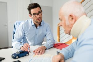 Personal injury lawyer sit with a claimant. 