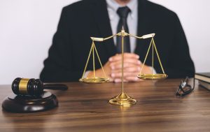 PERSONAL INJURY SOLICITOR SEATED AT DESK 