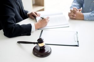 A client explains to a lawyer that he stood on a nail at work