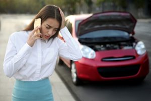 Woman talking on phone after road traffic accident.