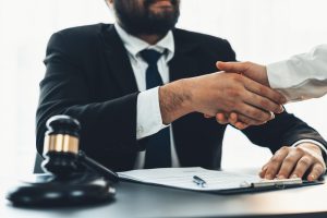 A bicycle accident lawyer shaking hands with his client.